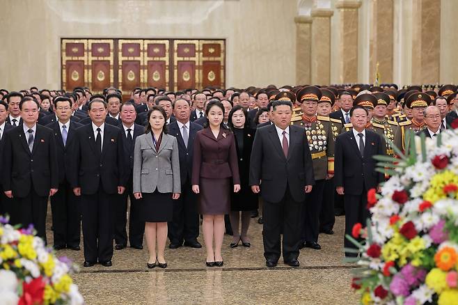 North Korean leader Kim Jong-un, left in the front row, is accompanied by his daughter Kim Ju-ae, center, and his wife Ri Sol-ju, in a visit to the Kumsusan Palace of the Sun with senior government and military officials on Jan. 1, 2026, as seen in this photo released by the state-run Rodong Sinmun on Jan. 2, 2026. [RODONG SINMUN]