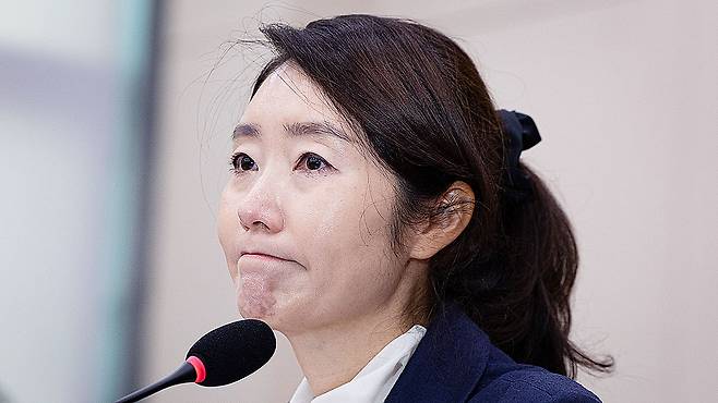 Rep. Kang Sun-woo, then a Democratic Party lawmaker and nominee for minister of gender equality and family, listens to questions with a stern expression during her confirmation hearing at the National Assembly in Yeouido, Seoul, on July 14, 2025. The Democratic Party expelled Kang from the party on Jan. 1, 2026, over allegations that she received money in connection with nominations for city council seats. [NEWS1]