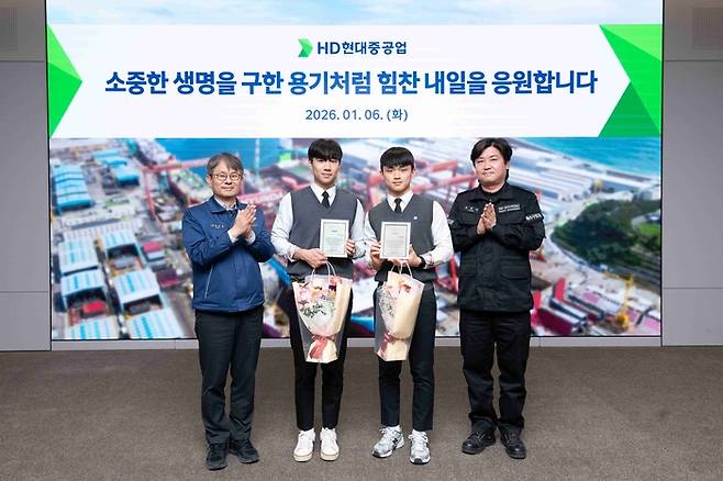 HD현대중공업이 시민의 생명을 구한 직원 자녀 등 학생 2명을 회사로 초청해 표창장과 장학금을 전달했다. 사진 왼쪽부터 HD현대중공업 금석호 사장, 문현서 군, 윤재준 군, HD현대중공업 윤형민 기사