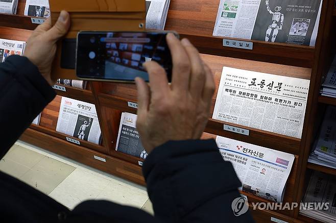 북한 노동신문 촬영하는 시민 (서울=연합뉴스) 신현우 기자 = 7일 국회도서관에 비치된 북한 노동당 기관지 노동신문을 시민이 촬영하고 있다.
    국회도서관 관계자는 지난 5일 오후부터 노동신문을 비치했다고 설명했다. 2026.1.7 nowwego@yna.co.kr
