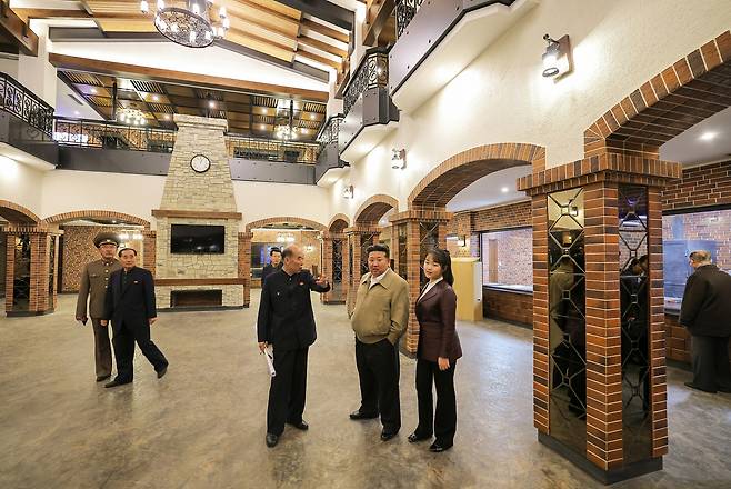 North Korean leader Kim Jong-un, second to right, inspects preparations to open major service facilities in the third-stage section of Pyongyang’s Hwasong area with his daughter Kim Ju-ae, right, in April 2025. [RODONG SINMUN]