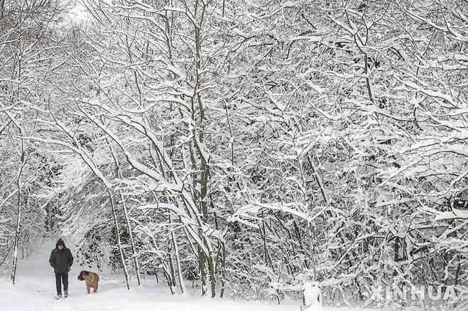[부다페스트=신화/뉴시스] 7일(현지 시간) 헝가리 부다페스트에서 한 남성이 반려견과 함께 눈길을 걷고 있다. 2026.01.08.