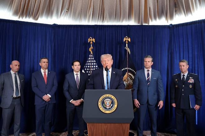 U.S. President Donald Trump holds a press conference as Secretary of Defense Pete Hegseth, second from right, U.S. Secretary of State Marco Rubio, third from left, and General Dan Caine, chairman of the Joint Chiefs of Staff, far right, look on following a U.S. strike on Venezuela where President Nicolas Maduro and his wife, Cilia Flores, were captured, from Trump's Mar-a-Lago club in Palm Beach, Florida, on Jan. 3. [REUTERS/YONHAP]