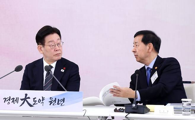 이재명 대통령이 지난 1월 9일 청와대에서 열린 경제성장전략 국민보고회에서 구윤철 부총리와 자료를 보며 이야기를 나누고 있다.[사진 | 뉴시스]