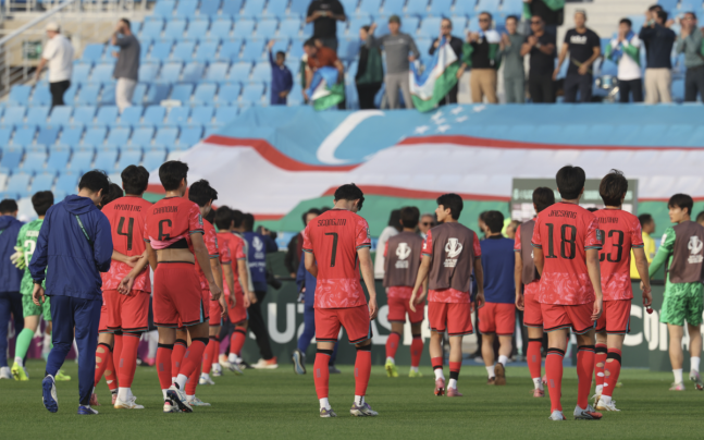 한국 U-23 대표팀 선수들이 13일 우즈벡에게 패한 뒤 그라운드를 뼈져나가고 있다. KFA 제공