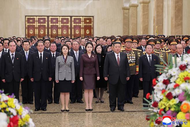 North Korean leader Kim Jong-un, second from right in the front row, attends a New Year's Day ceremony to pay respects to his father, Kim Jong-il, and his grandfather and regime founder Kim Il Sung at the Kumsusan Palace of the Sun in Pyongyang in this photo released by the North's state-controlled Korean Central News Agency on Jan. 2. His daughter stands between him and his wife Ri Sol-ju. [YONHAP]
