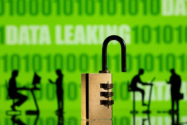 3-D printed models of people work on computers with a padlock in the foreground in front of the text "data leaking" and binary code in this illustration from Feb. 1, 2022. [REUTERS/YONHAP]