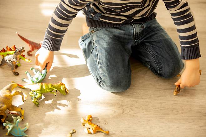 A child plays with dinosaur toys. The photo is used for illustrative purposes. [GETTY IMAGES]