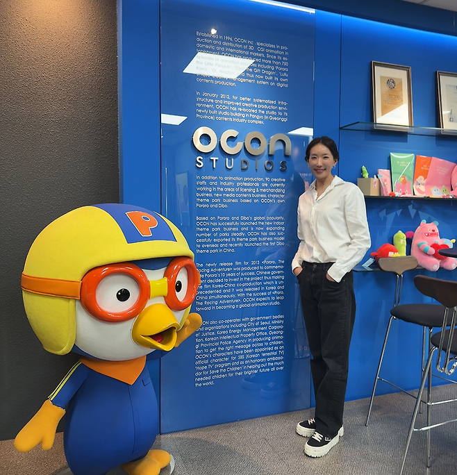 Woo Jee-hee, CEO of OCON, poses with the Pororo character at her office in Seongnam, Gyeonggi Province, in December 2025. (OCON)