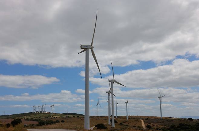 Wind turbines spin in a field near Casares, Spain, on July 12, 2025. [REUTERS/YONHAP]