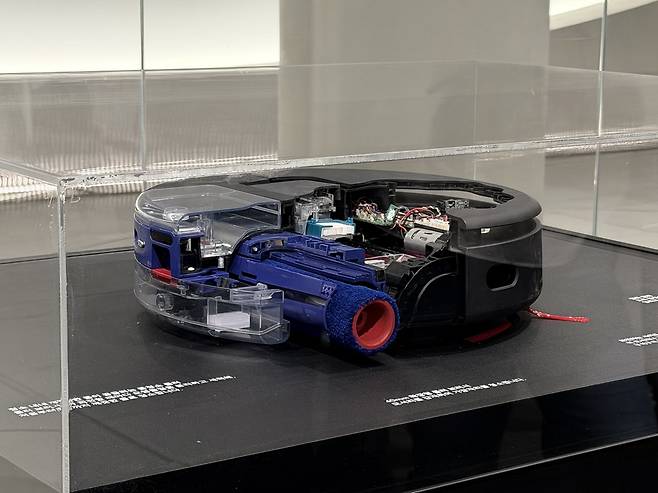 A cutaway model of Dyson’s Spot+Scrub Ai robot vacuum reveals its internal cleaning system, including a heated roller that rinses with clean water during use and extends up to 40 millimeters to reach floor edges. (Moon Joon-hyun/The Korea Herald)