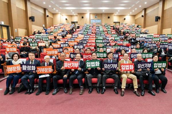 사진= 조명환 월드비전 회장(오른쪽에서 세번째)이 21일 오전 국회의원회관에서 열린 유산기부 활성화를 위한 한국의 ‘레거시 텐(Legacy 10)’ 제도 도입에 관한 정책 토론회에서 손피켓을 들고 기념촬영을 하고 있다. (사진 제공=월드비전)