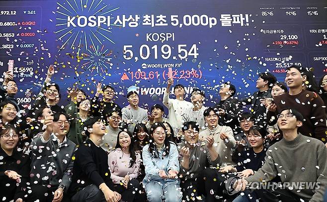 코스피, 장중 사상 첫 5,000선 돌파 (서울=연합뉴스) 김인철 기자 = 코스피 지수가 장중 사상 처음으로 5,019.54를 기록한 22일 서울 중구 우리은행 본점 딜링룸에서 딜러들이 코스피 지수 5,000선 돌파를 축하하고 있다. 2026.1.22 yatoya@yna.co.kr