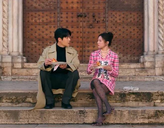 이탈리아의 서정적인 풍경 속에서 돋보인 샤넬 핑크 플래드 프린트 수트. 넷플릭스.