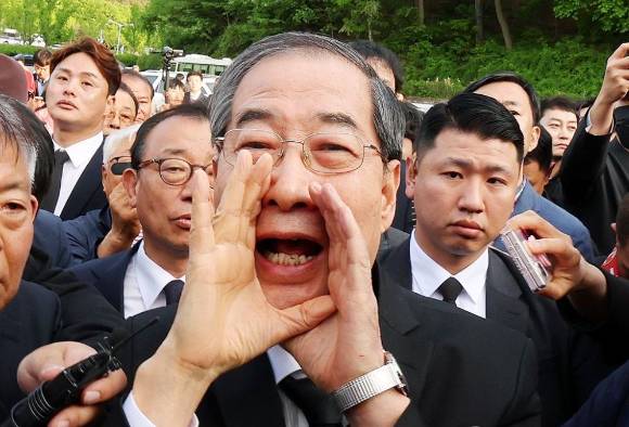 지난해 5월 2일 오후 광주 북구 국립 5·18 민주묘지를 찾은 한덕수 전 총리가 광주비상행동 등 시민·사회단체 관계자들의 반발에 가로 막히자 "저도 호남 사람"이라며 참배를 호소하고 있다. [사진=연합뉴스]