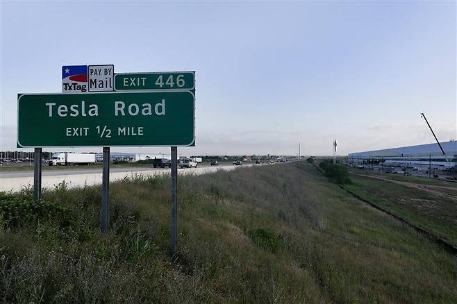 A highway sign for Tesla Road is seen near the Tesla Giga Texas factory on May 17, 2022, in Austin, Texas. [GETTY IMAGES]