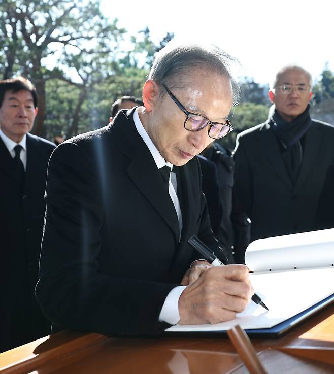 이명박 전 대통령이 새해 첫날인 지난달 1일 서울 동작구 국립서울현충원에서 현충탑 참배를 마친 뒤 방명록을 작성하고 있다. 연합뉴스