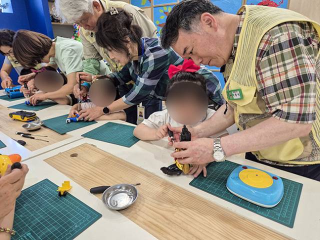 부산시는 올해 노인 일자리 7만 1027개를 창출할 계획이다. 사진은 지난해 친환경 노인 일자리 ‘ESG여행 도슨트’ 사업의 참여자가 아이들과 장난감 분해 체험을 하는 모습. 부산시 제공