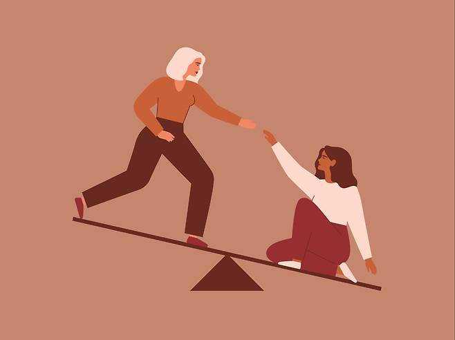 Picture of two women on a sesaw [GETTY IMAGE BANK]