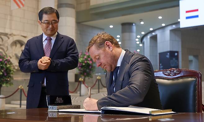 11일 서울 용산 전쟁기념관을 방문한 다비드 반 베일&nbsp;네덜란드 외교부 장관(오른쪽)이 방명록에 서명하는 동안 기념관 관리 주체인 전쟁기념사업회 백승주 회장이 이를 지켜보고 있다. 전쟁기념사업회 제공