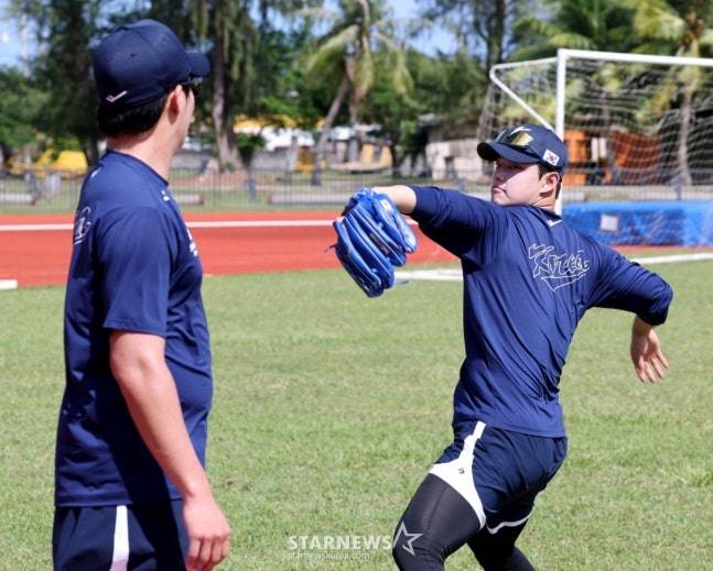 문동주(오른쪽)가 캐치볼 훈련을 마치고 원태인에게 조언을 구하고 있다. /사진=강영조 선임기자