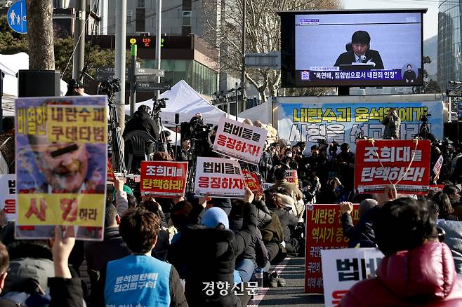 법원이 12·3 불법계엄과 관련해 내란 우두머리 혐의로 기소된 윤석열 전 대통령의 1심에서 무기징역을 선고한 19일 서울중앙지방검찰청 앞에서 시민들이 선고 방송을 시청하고 있다. 문재원 기자