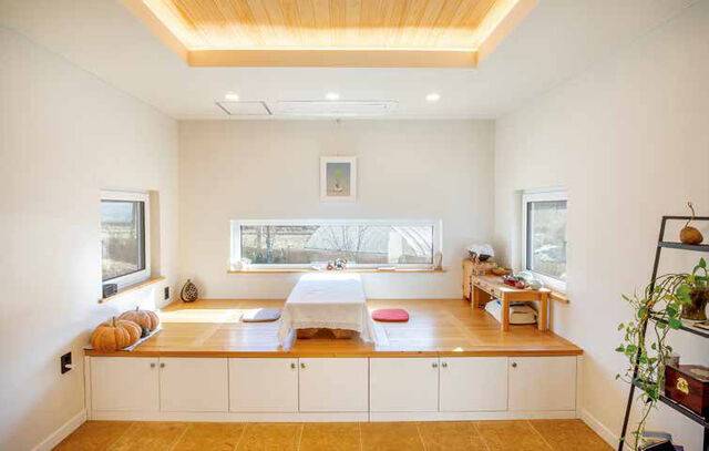 가로로 긴 슬라이딩 창 아래로 좌식 공간이 놓인 서재. 바닥엔 가공하지 않은 자연 황토로 만든 황암토타일을 깔았다.