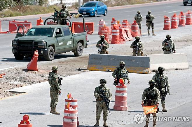 22일 멕시코 과달라할라 국제공항 진입로에서 경계 근무하는 멕시코 군인들 [AFP=연합뉴스. 재판매 및 DB 금지]