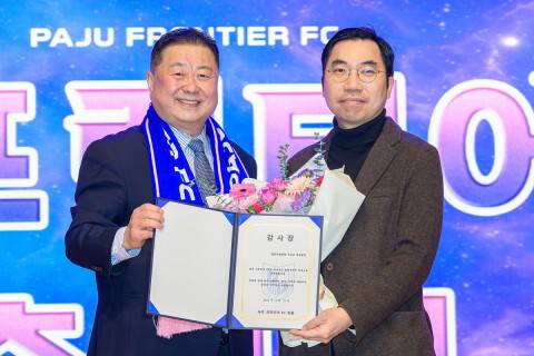 K리그2 파주 프런티어FC 구단주인 김경일 파주시장(왼쪽)이 서상교 SNU서울병원 대표원장에게 감사장을 전달한 후 기념사진을 찍고 있다. <파주시 제공>