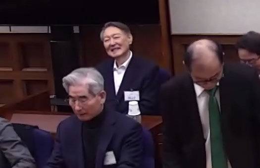 윤석열(왼쪽 위) 전 대통령이 19일 서울 서초구 서울중앙지방법원에서 열린 내란 우두머리 혐의 사건 1심 선고기일에서 변호인과 대화하며 잠시 미소짓고 있다. 법원은 내란 우두머리 혐의로 기소된 윤 전 대통령에게 무기징역을 선고했다. (사진= 서울중앙지법 제공)