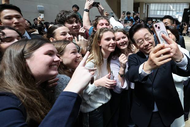 이재명 대통령이 26일 서울 용산구 국립중앙박물관에서 열린 특별전 ‘우리들의 이순신’을 관람한 뒤 외국인 관광객들과 기념촬영을 하고 있다. 뉴스1