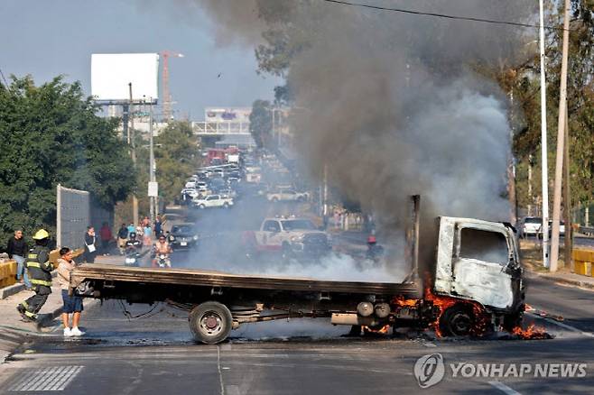 한국 대표팀이 조별리그 12차전을 치르는 멕시코 과달라하라에서 카르텔 조직원의 방화로 차량이 불타고 있다. 사진=AFPBBNews