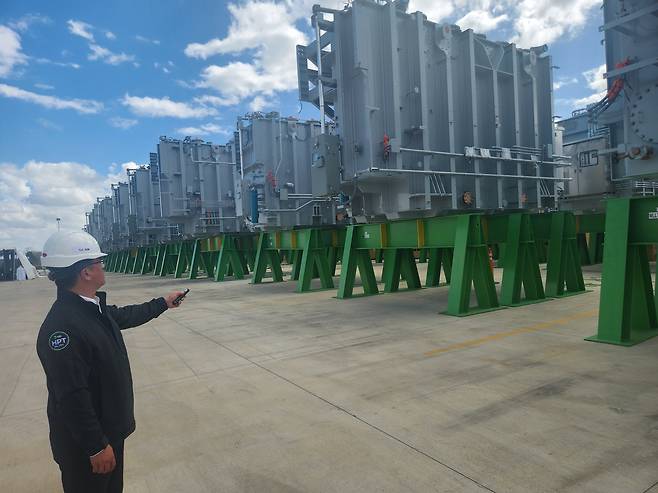 미국 출하 기다리는 HD현대 일렉트릭 변압기 (몽고메리[美앨라배마州]) 이종원 통신원= HD현대일렉트릭은 6일(현지시간) 미국 앨라배마주 몽고메리시에 위치한 북미 생산법인에서 제2공장 기공식을 개최했다. 이 공장의 김영철 최고운영책임자(COO)가 공장 내 변압기 전용 보관장을 점검하고 있다. higher2501@yna.co.kr 2026.3.7