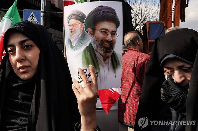 모즈타바 하메네이 사진 들고 있는 이란 여성 [테헤란 AFP=연합뉴스. 재판매 및 DB 금지]