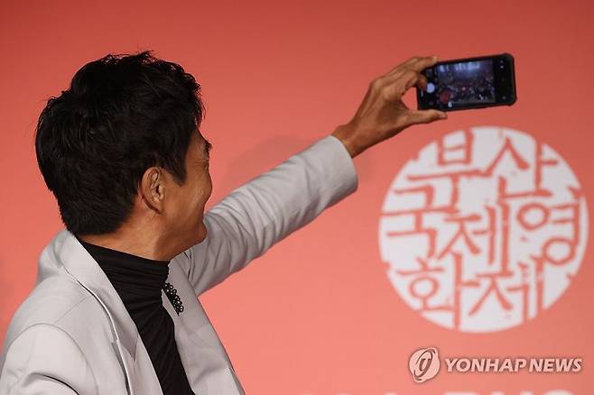 홍콩 배우 저우룬파(주윤발)이 5일 오후 부산 해운대구 KNN시어터에서 제28회 부산국제영화제 올해의 아시아영화인상 기자회견에서 개인 휴대전화로 기념촬영을 하고 있다. /사진=연합뉴스