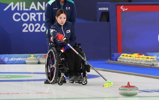 Korea’s Baek Hye-jin delivers a stone during the wheelchair curling mixed doubles semifinal against the United States at the 2026 Milan-Cortina Winter Paralympics at the Cortina Curling Olympic Stadium in Cortina, Italy, on March 10. [YONHAP]