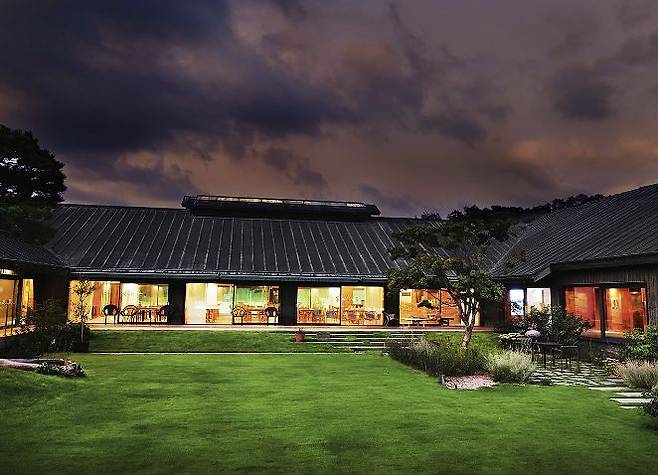 청동 지붕 아래 은은한 불빛이 새어 나오는 세레니티 청주 클럽하우스의 저녁 풍경. 사진 세레니티 골프장