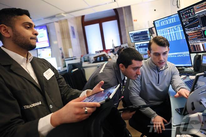 12일(현지시간) 뉴욕증권거래소(NYSE) 트레이딩 플로어에서 트레이더들이 장중 거래를 진행하고 있다.2026.3.12ⓒ AFP=뉴스1