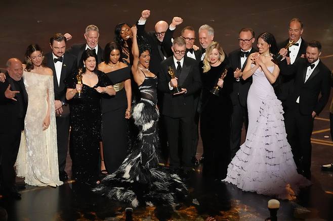Jose Antonio Garcia, from left, Florencia Martin, Leonardo DiCaprio, Cassandra Kulukundis, Regina Hall, Shayna McHale, Teyana Taylor, Michael Bauman, Paul Thomas Anderson, Anthony Carlino, Will Weike, Sara Murphy, Chase Infiniti, Christopher Scarabosio, and Andy Jurgensen accept the award for best picture award for “One Battle After Another” during the Oscars on Sunday, March 15, 2026, at the Dolby Theatre in Los Angeles. (AP Photo/Chris Pizzello)