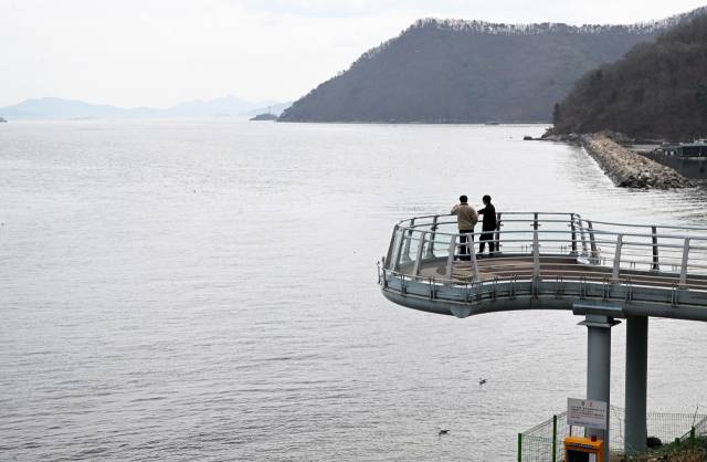 창원시 마산합포구 가포수변공원 해양전망대에서 시민들이 마산만을 바라보고 있다./김승권 기자/