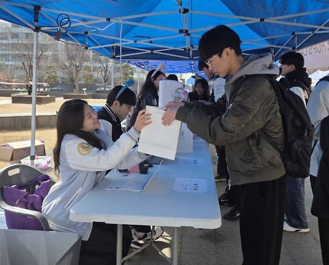 외국어대생들을 찾아 웰컴키트를 전달하고 있다.