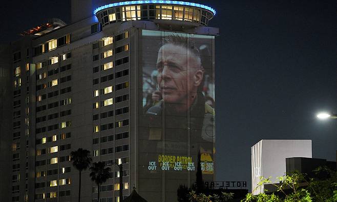 미국 아카데미 영화상 시상식을 앞둔 지난 14일(현지시간)&nbsp;행사장에서 가까운 LA 시내의 한 호텔 벽면에 그렉 보비노 전 국경순찰대장의 얼굴 이미지가&nbsp;투사되고 있다. 이는 도널드 트럼프 대통령의 반이민 정책에 항의하는 차원이다.&nbsp;로이터연합뉴스