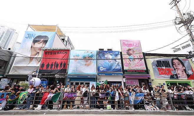지난 2025년 6월 10일 방탄소년단(BTS) 멤버 RM, 뷔의 전역날 서울 용산구 하이브 사옥 앞에서 방탄소년단(BTS) 팬들이 멤버들의 제대를 축하하며 노래를 부르고 있다. 뉴시스