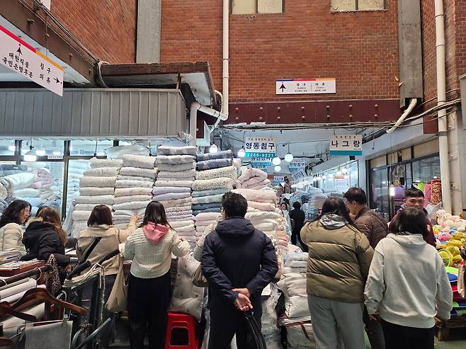 지난 19일 오후 서울 종로구 광장시장 침구 매장에서 외국인 관광객들이 이불을 고르고 있다. /권유정 기자