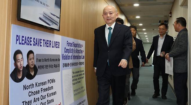 안창호 인권위원장이 23일 오후 서울 중구 국가인권위원회에서 열린 제6차 전원위원회 회의에 참석하러 입장하고 있다. 회의장 입구에는 우크라이나 북한군 포로 송환을 요구하는 북한인권단체의 팻말이 세워져 있다. 김정효 기자 hyopd@hani.co.kr