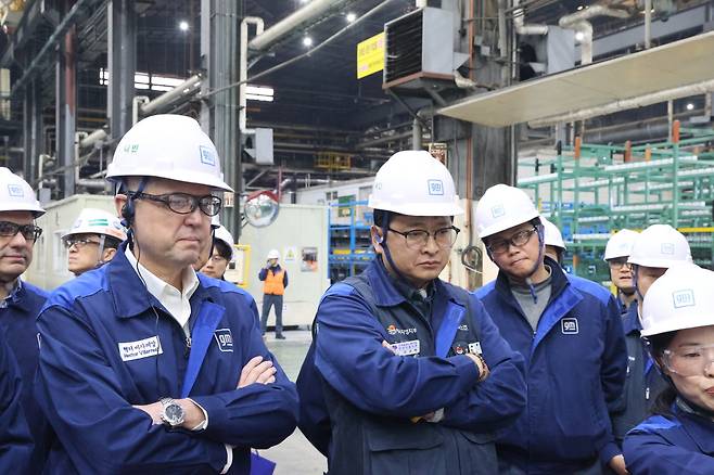 Hector Villarreal, president and CEO of GM Korea (left) and Ahn Gyu-baek, head of the GM Korea chapter of the Korean Metal Workers’ Union (second from left), listen to an explanation of for press equipment at the company's Bupyeong plant on Wednesday. (GM Korea)