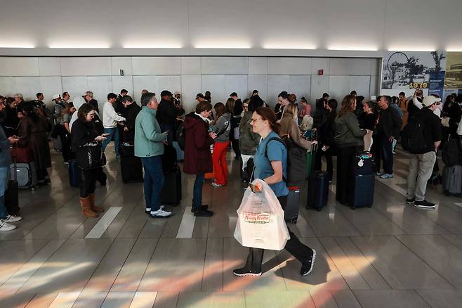25일 미국 뉴욕시 라과디아 공항에서 사람들이 보안 검색대를 통과하기 위해 긴 줄을 서서 기다리고 있다. AFP연합뉴스