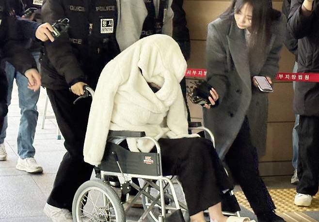 약물을 투약한 상태로 차량을 몰다 반포대교 난간을 뚫고 추락한 30대 여성 A씨가 지난달 27일 서울서부지법에서 열린 구속 전 피의자 심문(영장실질심사)에 휠체어를 타고 출석하고 있다. A씨는 지난 25일 오후 8시 44분ㄲ 포르쉐 SUV를 몰고 반포대교를 달리다 난간을 들이받고 잠수교 인근 한강 둔치로 추락한 혐의를 받는다. 뉴스1