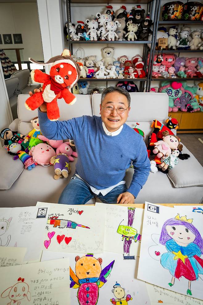 '고마저씨' 박성일 고마컴퍼니 대표가 '나만의 인형'을 들고 환하게 웃고 있다. 박 대표는 "인형을 만드는 내내 아이들이 인형을 안고 활짝 웃는 모습을 상상한다"고 말했다. 박대표 앞으로 아이들의 그림 편지가, 뒤로 인형들이 보인다./ 이건송 영상미디어 기자
