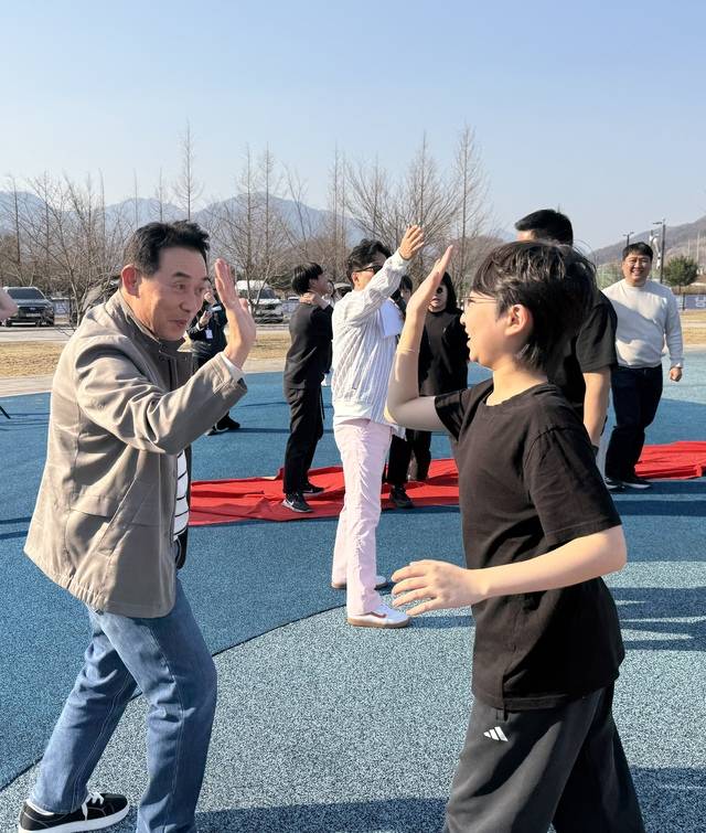 백영현 (왼쪽) 포천시장이 다둥이 가족 별밤 캠핑에 참가한 한 아이와 하이파이브를 하고 있다. 사진=박성용 기자